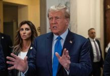 Trump Attorney RANSACKED – Office Flipped! Man speaking with hands raised, woman and security behind.