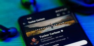 Tucker REFUSES Apology — Media Elites Furious Smartphone displaying a YouTube channel profile page.