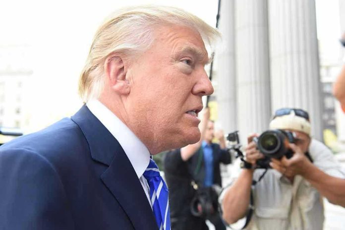 Man in suit with photographers in background.