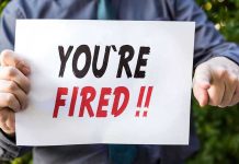 Verizon Corporate Bloodbath: 15,000 Jobs Axed Overnight! Person holding YOURE FIRED sign.