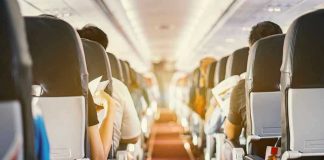 Emergency Evacuation: Chilling On-Flight Discovery! Passengers seated inside an airplane cabin.