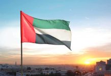 United Arab Emirates flag waving against a sunset backdrop