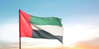 Arabic ONLY Schools in US—Who’s Really in Charge? United Arab Emirates flag waving against a sunset backdrop