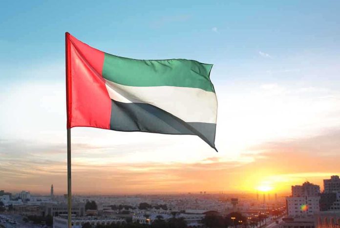 United Arab Emirates flag waving against a sunset backdrop