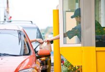 SNAP COLLAPSES: Fast Food Chain STEPS IN! Customer receiving a food order at a drive-thru window