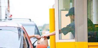 SNAP COLLAPSES: Fast Food Chain STEPS IN! Customer receiving a food order at a drive-thru window
