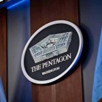 Admiral DEFENDS Hegseth – Says It WASN’T Him The Pentagon emblem between two flags.