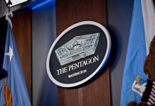 Admiral DEFENDS Hegseth – Says It WASN’T Him The Pentagon emblem between two flags.