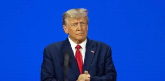 Trump NARROWS Fed Pick to Two – Decision Soon! Man in a suit with a blue background.