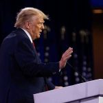 Trump SIEZES Venezuela Tanker – Sparks High-Seas SHOWDOWN! Person speaking at a podium with hand raised