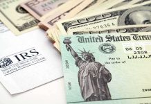 A tax refund check from the IRS alongside various denominations of cash