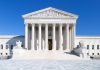 SCOTUS Takes Case – Most Unconstitutional EVER! The Supreme Court building featuring marble columns and a clear blue sky