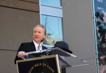 Woke Liberal Guest SHOCKS Maher With Bombshell A man in formal attire speaking at a podium during a Hollywood Walk of Fame ceremony