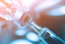 Measles OUTBREAK: State Begins Mandatory Quarantine Close-up of a syringe drawing liquid from a vial