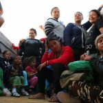 Group of people sitting in a truck.