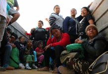 Group of people sitting in a truck.