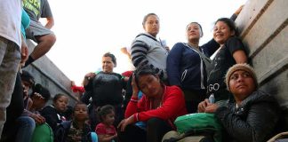 Group of people sitting in a truck.