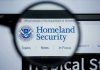 Magnifying glass showing Homeland Security website.
