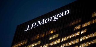 Illuminated J.P. Morgan building at night with visible office windows