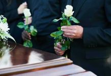 2-Time Presidential Hopeful, Dies Aged 84 Mourners holding white roses by a casket.