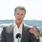 “Atrocity” Claim Ignites Democratic Panic Man speaking with microphone outdoors.