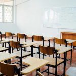 CLASSROOM SCANDAL: Kids FORCED to Protest ICE! Empty classroom with desks, chairs, and whiteboard.