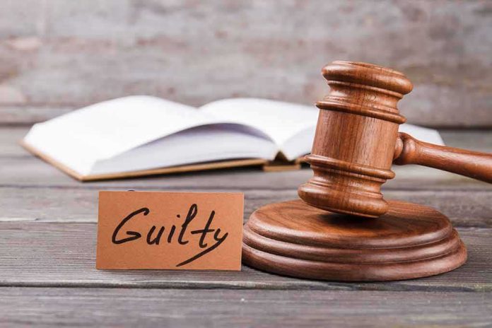 shutterstock_1906951639.jpg A wooden gavel next to a card that reads 'Guilty' and an open book