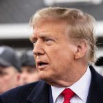 Trumps Right Hand Man QUITS – He’s Had Enough! Man in suit and red tie speaking outside.