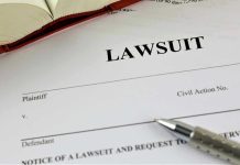 Meghan McCain Threatens Alex Jones With Lawsuit After Disgusting Smear Lawsuit document with a pen and book.