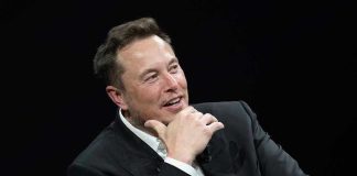 Musk’s Lawsuit EXPOSES OpenAI’s Hidden Agenda Man in suit smiling, resting chin on hand.