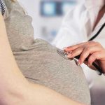 Abortion Amendment Hides SHOCKING Truth From Voters Doctor uses stethoscope on pregnant womans belly.