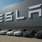 Cybertruck Recall Reveals Catastrophic Wheel Risk Tesla facility with parked cars in front.