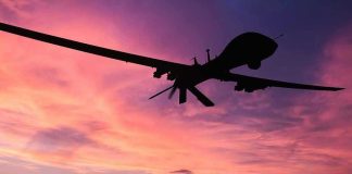 Cuba’s Drone Arsenal: Are U.S. Targets Next? Silhouette of a drone against a colorful sunset.