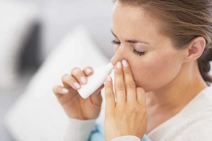 shutterstock_149120279-1 Woman applying nasal spray for relief