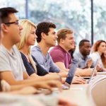 EXPOSED: Why Young Workers Can’t Survive Anymore A diverse group of students attentively listening in a classroom setting