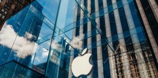 iPhone Pro Sticker Shock Looms Glass Apple store facade in urban setting