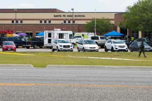 shutterstock_1093698077 High school parking lot with emergency vehicles and tents