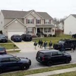 FBI agents conducting an operation in a suburban neighborhood