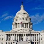 Housing Lifeline Stalled — Filibuster Trap Sprung US Capitol Building against blue sky.