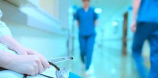 Hospitals Duped: Thousands Slip Past Boards A healthcare professional holding a stethoscope in a hospital corridor