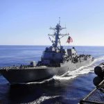 Strait Of Hormuz Boils — Truth Gagged naval destroyer sailing at sea with flag flying