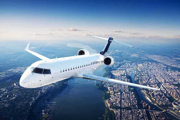 shutterstock_178012379 White regional jet flying over a city and river