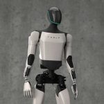 A humanoid robot designed by Tesla standing against a gray background