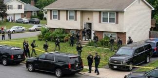 Fresh Evidence? Owens Reopens the Kirk Mystery Law enforcement officers conducting a raid in a residential neighborhood