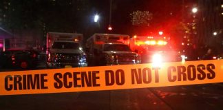 Mass Overdose Madness: Count Shifts, Trust Craters Crime scene tape with emergency vehicles in background.