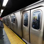 Rape Charges Rock London-Bound Train Man waiting at subway platform with departing train.