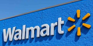 Stock Slides After Surprise Walmart Miss Walmart store exterior signage on blue wall