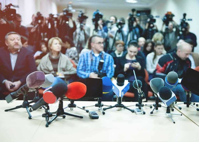 Row of microphones on a table at a press conference
