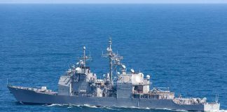 Gray naval warship cruising on open sea