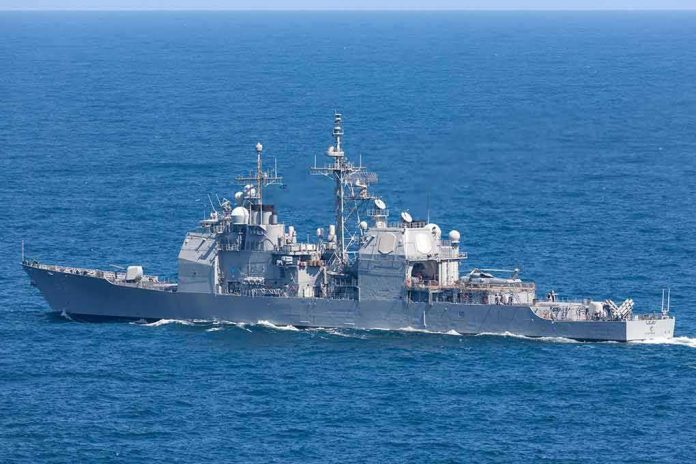 Gray naval warship cruising on open sea